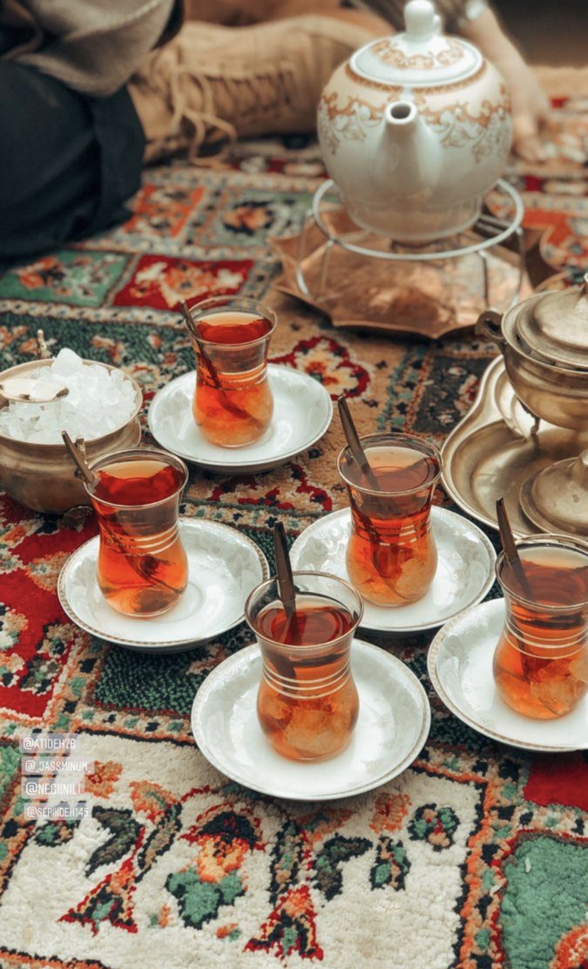 Persian tea glasses arranged on a rug